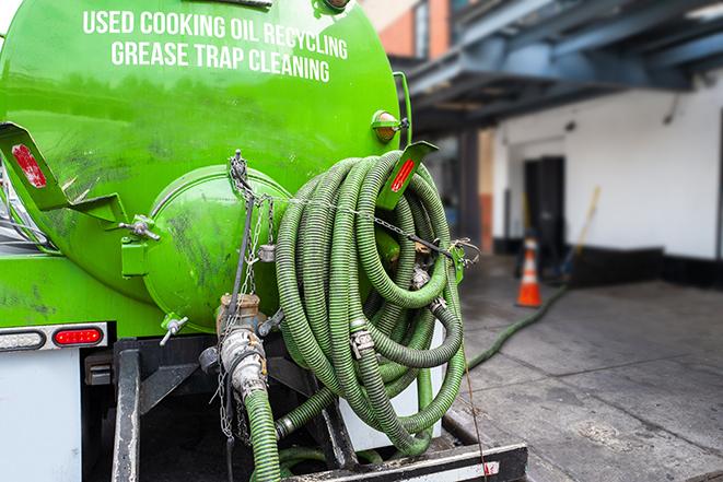 heavy-duty vacuum truck pumping out a grease trap in Angelus Oaks CA